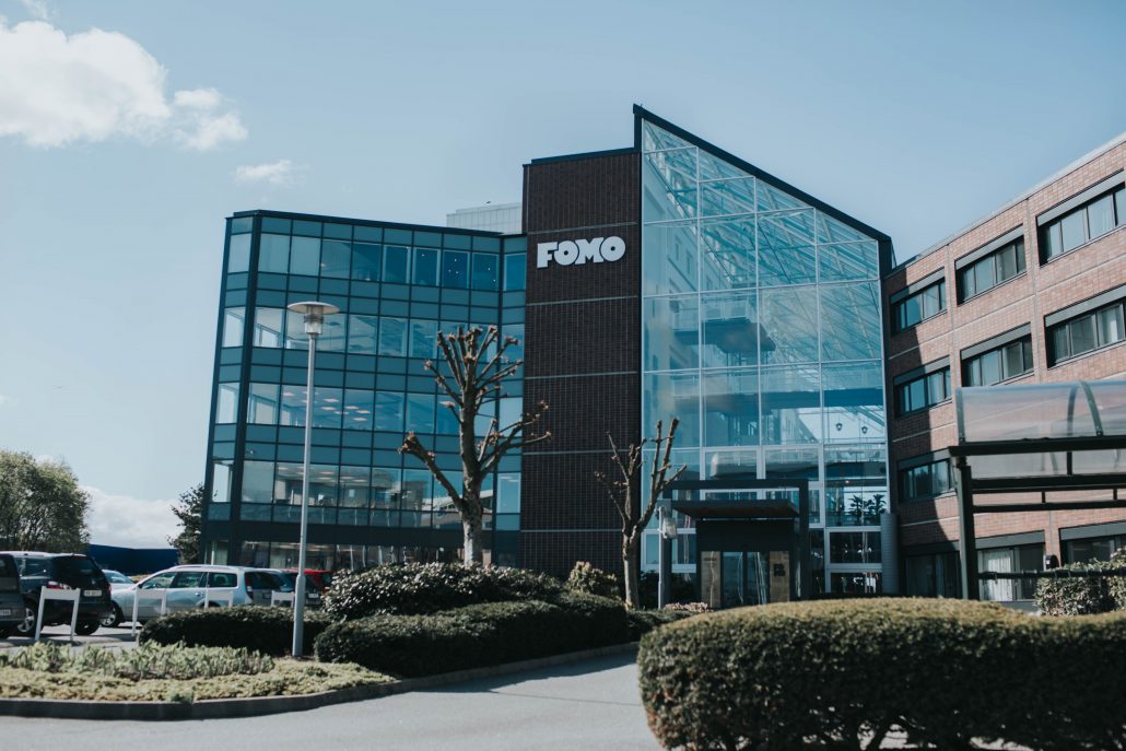 Fomo Works' building is covered with red bricks and glass walls. It is situated right next to Ikea and highway E39. 