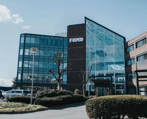 Fomo Works' building is covered with red bricks and glass walls. It is situated right next to Ikea and highway E39.