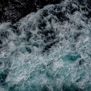 Deep blue ocean with surging white waves seen from above Deep blue ocean with surging white waves seen from above